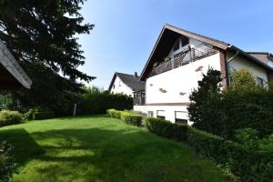 a house with a green lawn in front of it at Fewo Grohlz in Boos