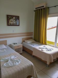 Een bed of bedden in een kamer bij Pousada Italianíssima