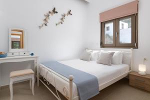 Säng eller sängar i ett rum på Villa Diafani, Anna