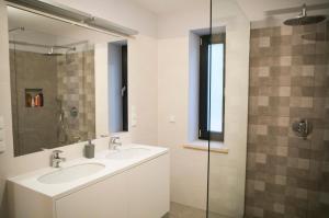 a bathroom with two sinks and a glass shower at Dom Mazurski Tumiany 3 B in Tumiany +25 photos