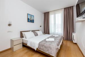 Ein Bett oder Betten in einem Zimmer der Unterkunft Apartments LORA in Apart-hotel
