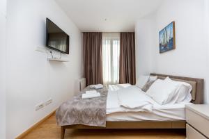 Ein Bett oder Betten in einem Zimmer der Unterkunft Apartments LORA in Apart-hotel