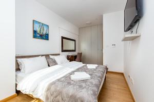 Ein Bett oder Betten in einem Zimmer der Unterkunft Apartments LORA in Apart-hotel