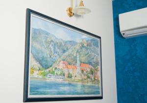 a painting of a hotel on a wall at Fontush Boutique Hotel in Ivano-Frankivsk