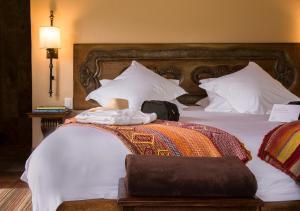 A bed or beds in a room at Inkaterra Hacienda Urubamba