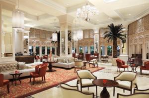 a lobby of a hotel with tables and chairs at Taj Samudra in Colombo