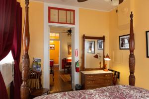 
a bedroom with a bed and a dresser at Blue60 Guest House in New Orleans
