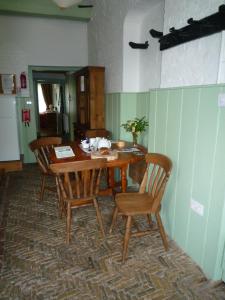 a dining room table and chairs in a room at Brackenborough Hall Coach House - Saddle Room in Louth