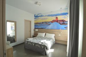 a bedroom with a bed with a painting on the wall at Casa Corvaja in Taormina