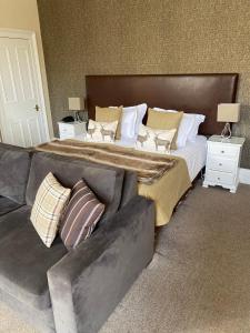 a bedroom with a large bed and a couch at No12 Hotel in North Berwick