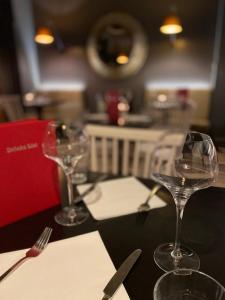 a table with two wine glasses on top of it at No12 Hotel in North Berwick