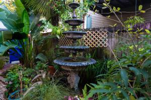 a bird bath in the middle of a garden at The Blue60 Marigny Inn in New Orleans