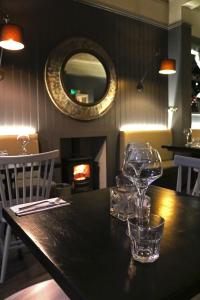 a table with wine glasses on it with a fireplace at No12 Hotel in North Berwick