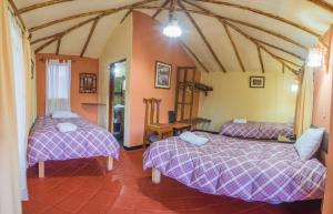 Rúm í herbergi á Hotel Kuntur Wassi