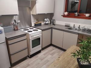 a kitchen with a stove and a sink at 2 Raasay Court in Portree