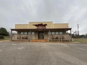 a building with a horse sign on the front of it at Flying L Ranch Resort in Bandera