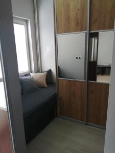 a room with a bench and a mirror at Apartment Nenov in Skopje