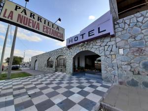 a hotel with a stone building with a sign at La Nueva Estancia in Santa Rosa