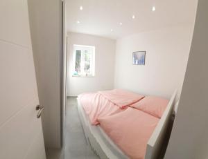 a small bedroom with a bed and a window at Villa Marija in Splitska