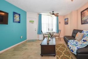 a living room with a couch and a table at Daytona Beach studio condo with beautiful Ocean view in Daytona Beach