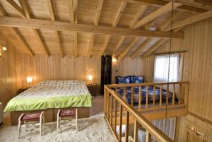 a bedroom with a bed in a wooden room at Chalet Parea in Metamorfosi