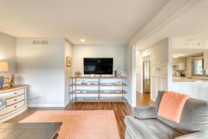 a living room with a couch and a tv at Fairway Oaks 1305 in Kiawah Island