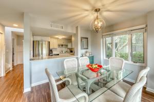 a dining room with a glass table and chairs at Fairway Oaks 1305 in Kiawah Island