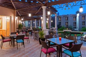 a patio at a hotel with tables and chairs at Crowne Plaza Bahrain by IHG in Manama