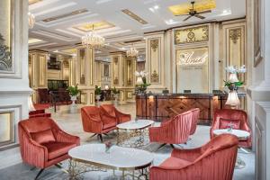 a restaurant with red chairs and tables and a bar at Anik Palace Hotel in Phnom Penh