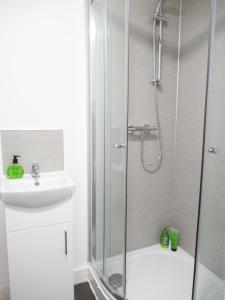 a bathroom with a shower and a sink at Emmanuel Church Apartments in Warrington