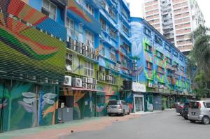 a colorful building with cars parked on a street at Omni Suites Hotel Bukit Bintang in Kuala Lumpur