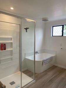 a bathroom with a bath tub and a shower at Terrace Apartment in Timaru +9 photos