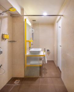 a bathroom with a sink and a shower at bloomrooms @ Janpath in New Delhi