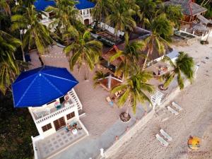 an overhead view of a beach with a blue umbrella at Lanas Beach Resort in San Jose