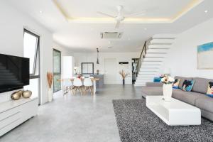 a living room with a couch and a tv at Villa Casa Bella - Private-Pool, Luxury Villa near Bangrak Beach in Koh Samui 