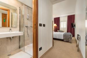 
a hotel room with a large bed and a large mirror at Hotel Dubrovnik in Zagreb
