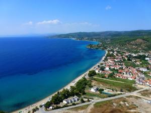 a beach with a large body of water at Miramare Hotel in Neos Marmaras