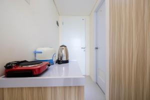 a kitchen with a counter with a appliance on it at Elegant Studio Apartment at Bogorienze By Travelio in Bogor +4 photos