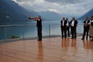 a group of men standing on a deck with a telescope at Seehotel Sternen in Brienz