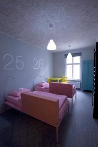 a room with two beds in a room with numbers on the wall at Hostel U Zlatého kohouta in Kroměříž
