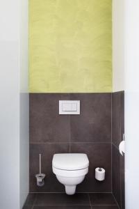 a bathroom with a white toilet in a room at eee Hotel Liezen in Liezen