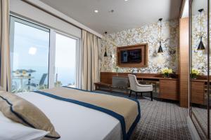 a hotel room with a bed and a desk at Royal Neptun Hotel in Dubrovnik