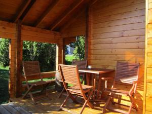 - une terrasse couverte avec une table et des chaises en bois dans l'établissement Pivarootsi Holiday Village, à Pivarootsi