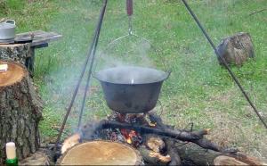 a pot on top of a bonfire with a fire at Göncölház in Vác