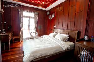 Postel nebo postele na pokoji v ubytování Baan Lhang Wangh บ้านหลังวัง