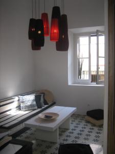 a living room with a couch and red lights at Apartamentos Casa del Coronel in Tarifa