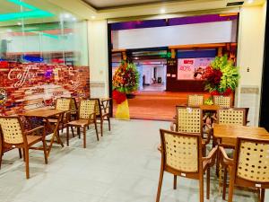 a dining room with tables and chairs and a store at Mekong Rose Hotel in Can Tho