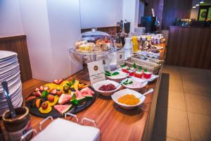 a buffet with many different types of food on a table at Hotel Korel in Poznań