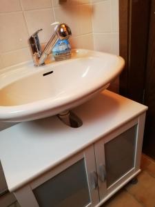 a bathroom with a white sink on a counter at Ferienhaus Klabautermann in Hage