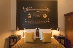 a bedroom with a bed with a black headboard at Scharffenberg Apartments Main Square in Krakow